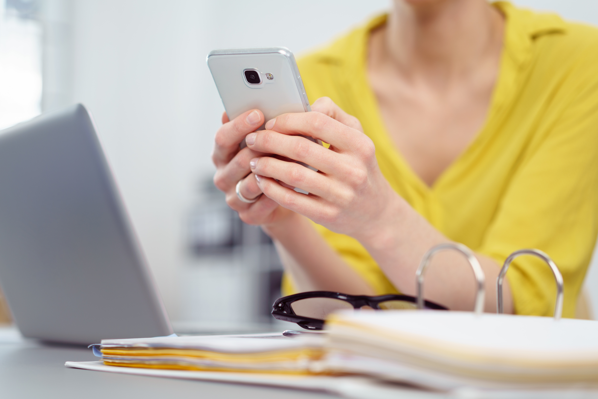 Woman checking hipaa compliant text appointment reminder